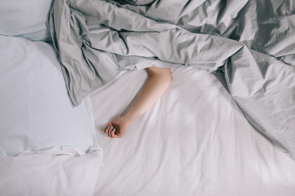cropped image of girl sleeping on bed covered with blanket - Φωτογραφία, εικόνα