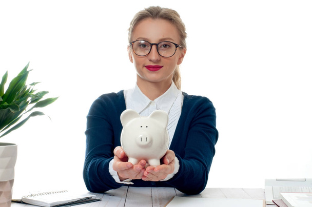 Business woman is holding piggy bank. Saving concept - Photo, Image