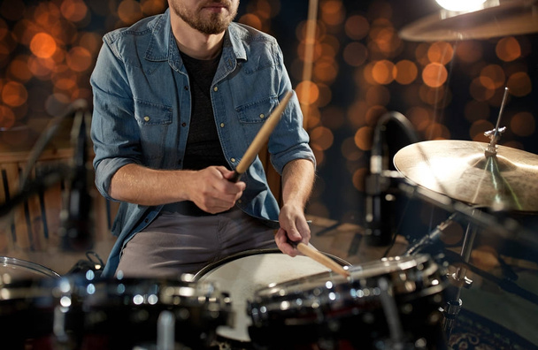 male musician playing drum kit at concert - Photo, Image
