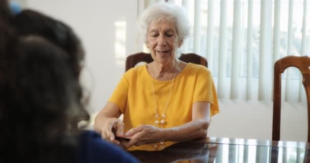 Granddaughter And Grandma Playing Magic Tricks With Cards At Home - Metraje, vídeo