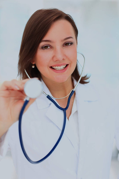 Close-up of female doctor using stethoscope. - Foto, afbeelding
