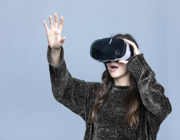 Young woman touching air during the VR experience  - Фото, зображення