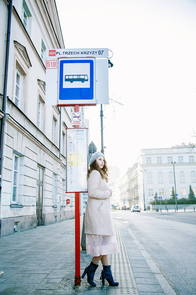 Nice Frenchwoman on the streets of the city. The girl walks around the city. An early walk. A young woman speaks through the phone and sends sms. - Photo, Image