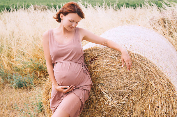 Beautiful pregnant woman in nature, outdoors.  - Φωτογραφία, εικόνα