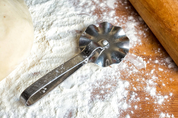 forms for squeezing the dough. dough on the table with dough tools. - Foto, Imagem