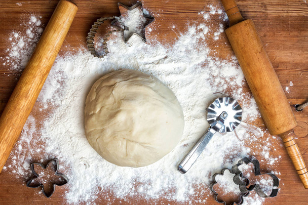 forms for squeezing the dough. dough on the table with dough tools. - Photo, Image