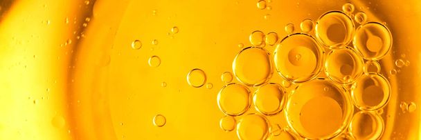 Yellow and orange bubbles, drops of oil in water, olive oil for cooking background. - Fotografie, Obrázek