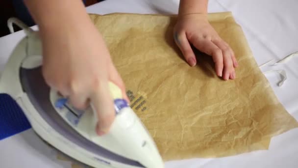 Female hands iron paper for making plastic odd job bee - Кадри, відео