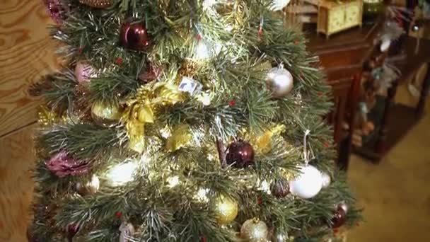 Kunstmatige naaldboom versierd met Kerstmis speelgoed op de kamer. - Video