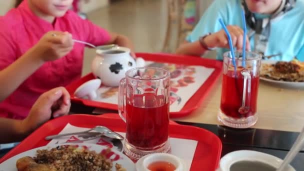 Family of three mother and two children has lunch in cafe. - Materiał filmowy, wideo