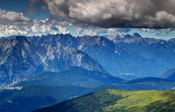 Sharp vertical Carnic Alps rock faces above Piave valley Italy - Valokuva, kuva