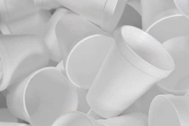 An abstract image of white disposable Styrofoam coffee cups in a heap.  - Foto, immagini