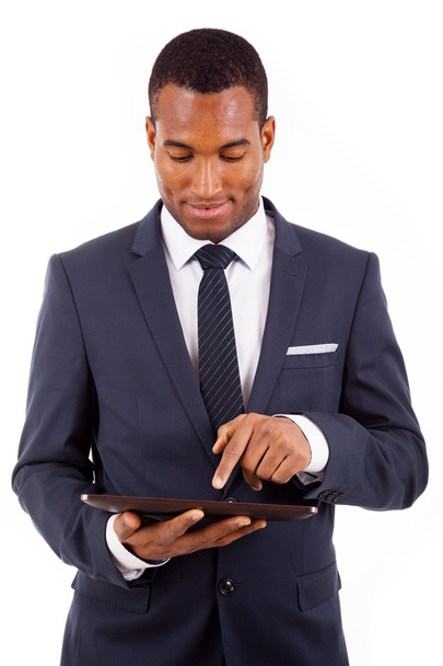 Thoughtful african american young businessman with tablet comput - 写真・画像