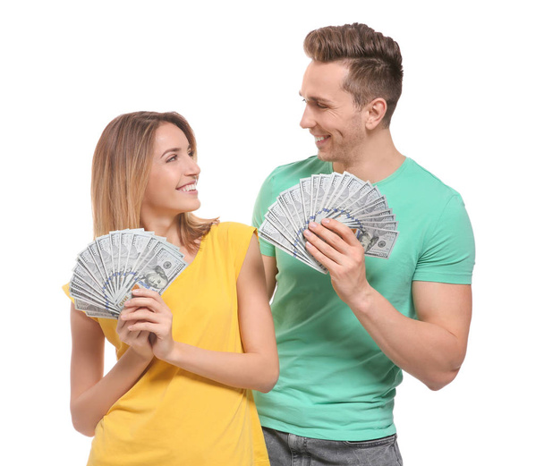 Young couple with money on white background - Фото, зображення