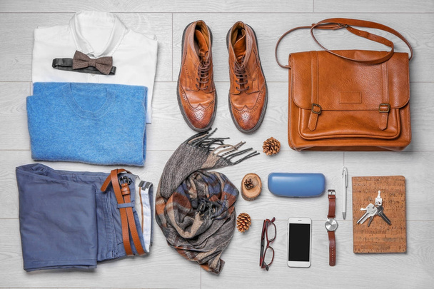 Set of hipster clothes on wooden floor, flat lay - Foto, afbeelding