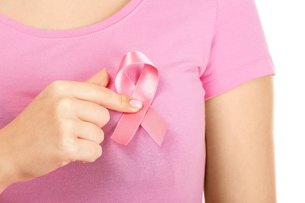 Woman showing pink ribbon on white background. Breast cancer awareness concept - Fotoğraf, Görsel