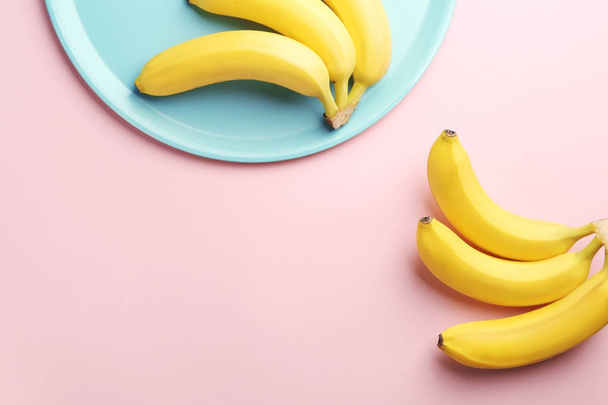 Composition with ripe bananas on color background - Fotó, kép
