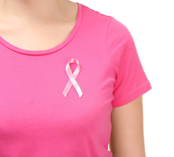 Woman with pink ribbon on t-shirt against white background. Breast cancer awareness concept - Foto, afbeelding
