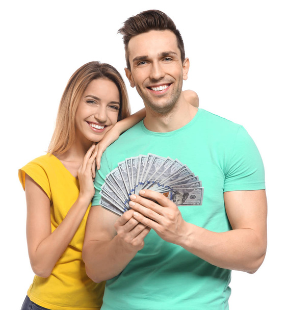 Young couple with money on white background - Фото, изображение