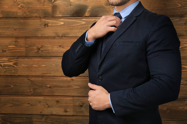 Handsome man in formal suit on wooden background, closeup - Foto, Imagem