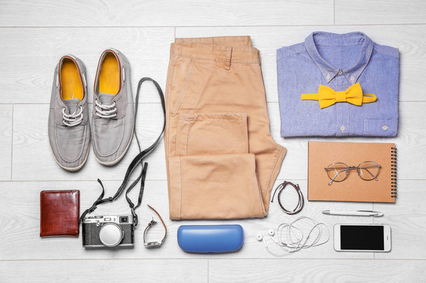 Set of hipster clothes on wooden floor, flat lay - Фото, зображення