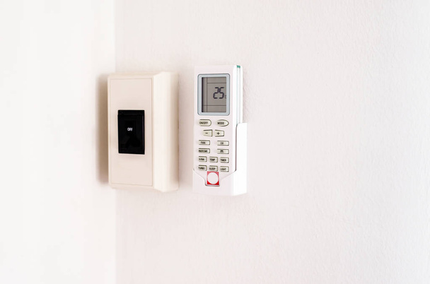 Remote Air Conditioner and Electronic Breaker on-off on wall - Foto, Bild