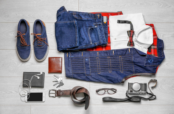 Set of hipster clothes on wooden floor, flat lay - Foto, Bild