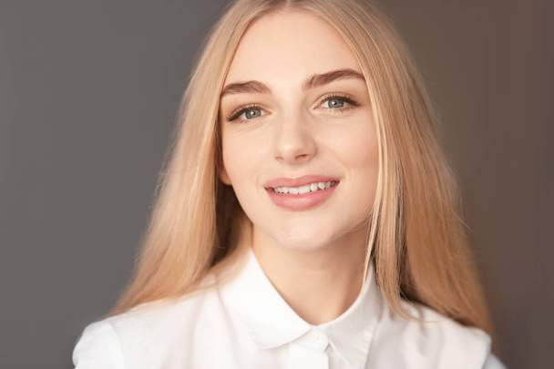 Smiling woman in white blouse on color background - Φωτογραφία, εικόνα