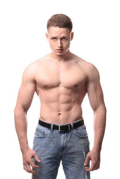 Muscular young bodybuilder on white background - Foto, Bild