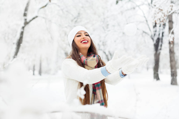 Attractive young woman in wintertime outdoor - Фото, изображение