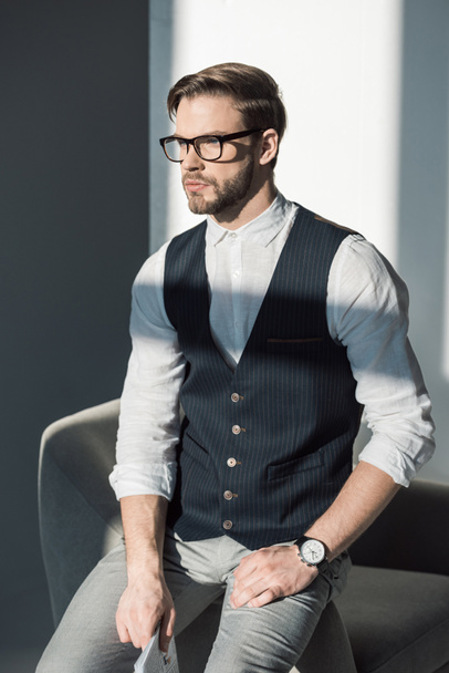 portrait of handsome stylish young businessman in eyeglasses looking away - Фото, зображення