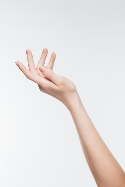 tiro recortado da mão feminina com a pele perfeita isolada no branco
 - Foto, Imagem