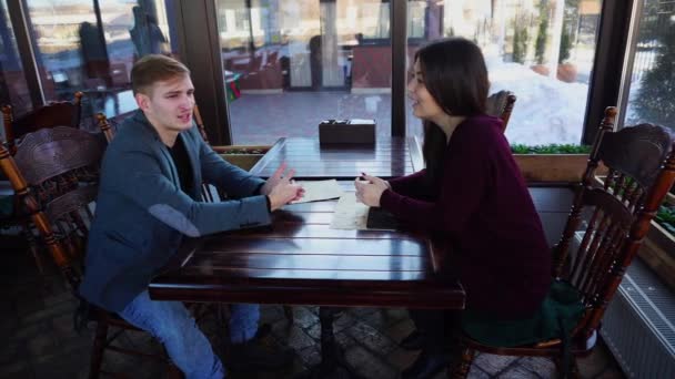 Married couple discussing relocation in coffee house. - Footage, Video