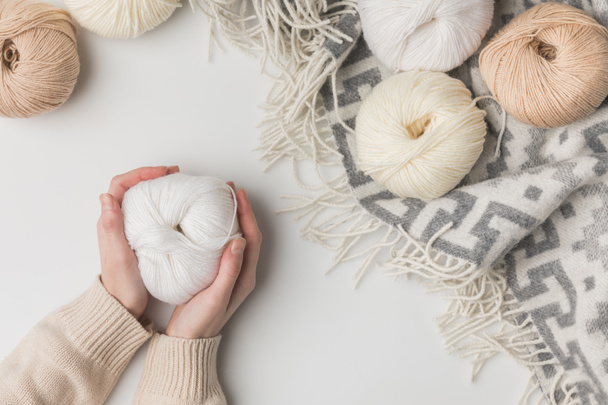 cropped view of woman holding white yarn ball on white background  - Photo, Image