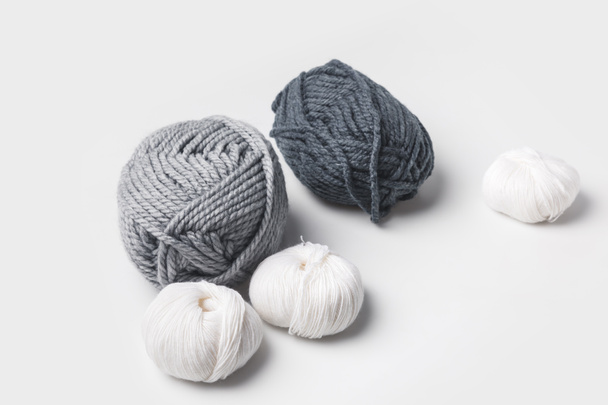 grey and white yarn balls isolated on white  - Фото, изображение