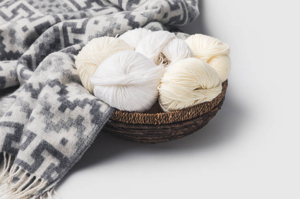 white yarn balls in wicker basket with blanket isolated on white     - Φωτογραφία, εικόνα