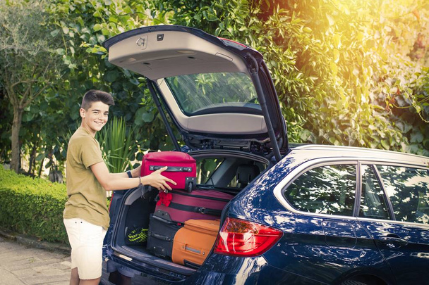 child with suitcases and car prepared for road travel - Photo, Image