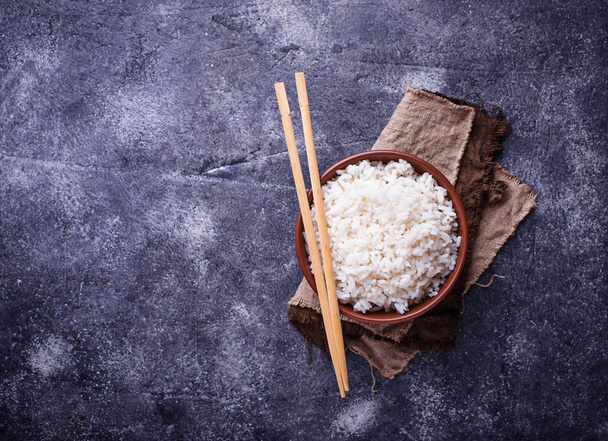 Bowl of boiled rice and chopsticks - Photo, Image