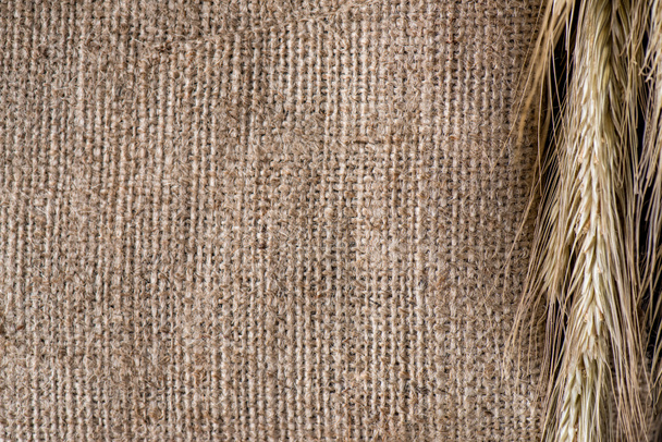 close up view of wheat on sackcloth background - Photo, Image