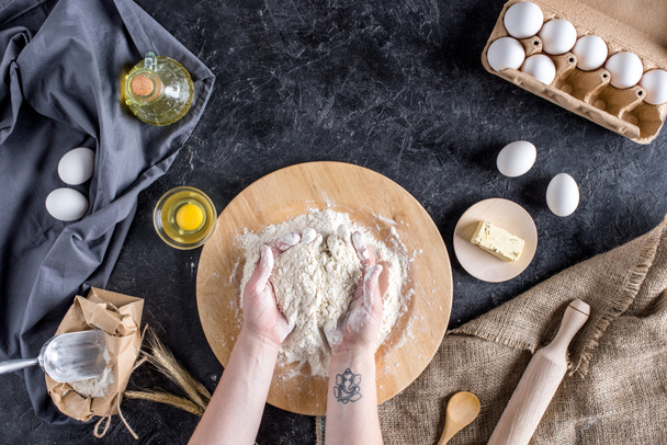 cropped shot of woman kneading dough for homemade bread  - Фото, зображення
