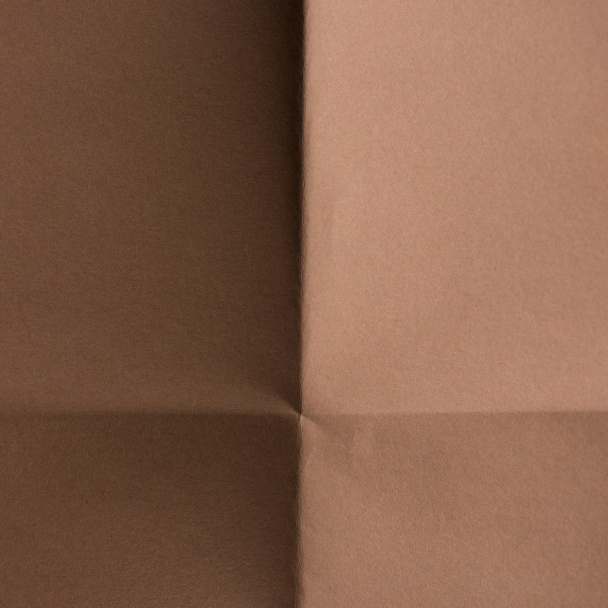 close-up shot of brown colored folded paper for background - Φωτογραφία, εικόνα