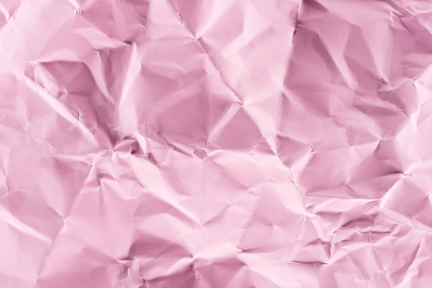 közeli lövés a gyűrött papír rózsaszín háttér - Fotó, kép