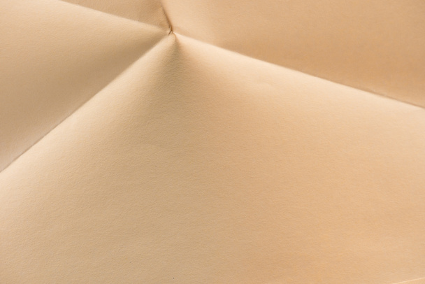 close-up shot of folded biege color paper - Foto, Imagem