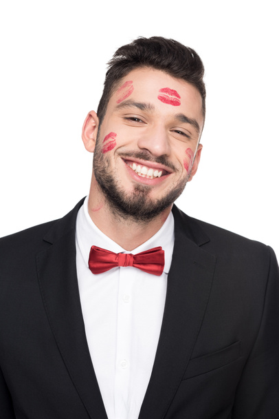 laughing handsome man with lips traces on face isolated on white - Fotó, kép
