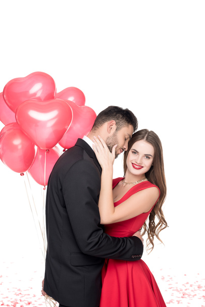 boyfriend with heart shaped balloons hugging girlfriend isolated on white, valentines day concept - Photo, Image