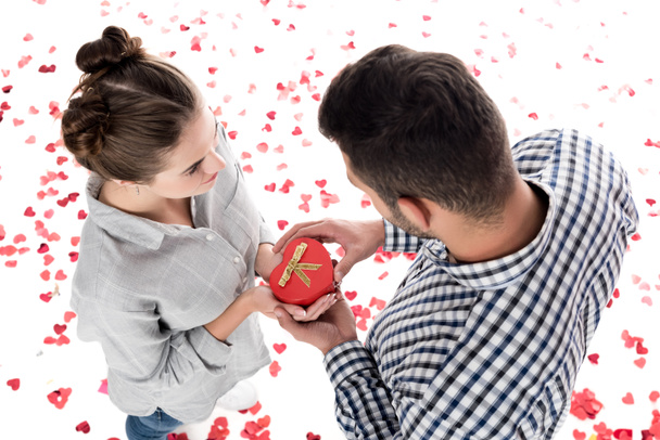overhead view of girlfriend giving boyfriend present box isolated on white, valentines day concept - 写真・画像