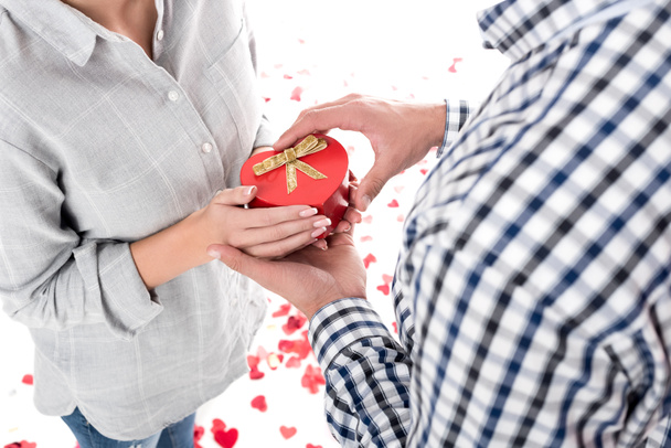 cropped image of girlfriend giving boyfriend present box isolated on white, valentines day concept - 写真・画像