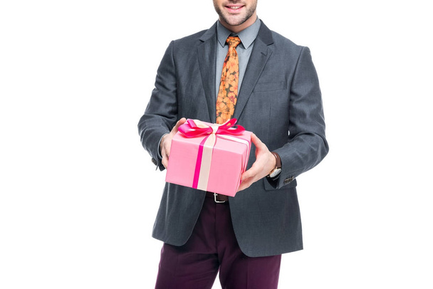 cropped view of beardman holding pink present, isolated on white - Fotó, kép
