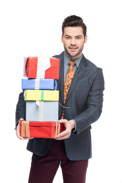 handsome man holding gift boxes, isolated on white - Foto, Bild