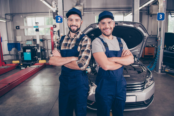 Welcome to our car service. Two experts  with arms crossed, smil - Photo, image